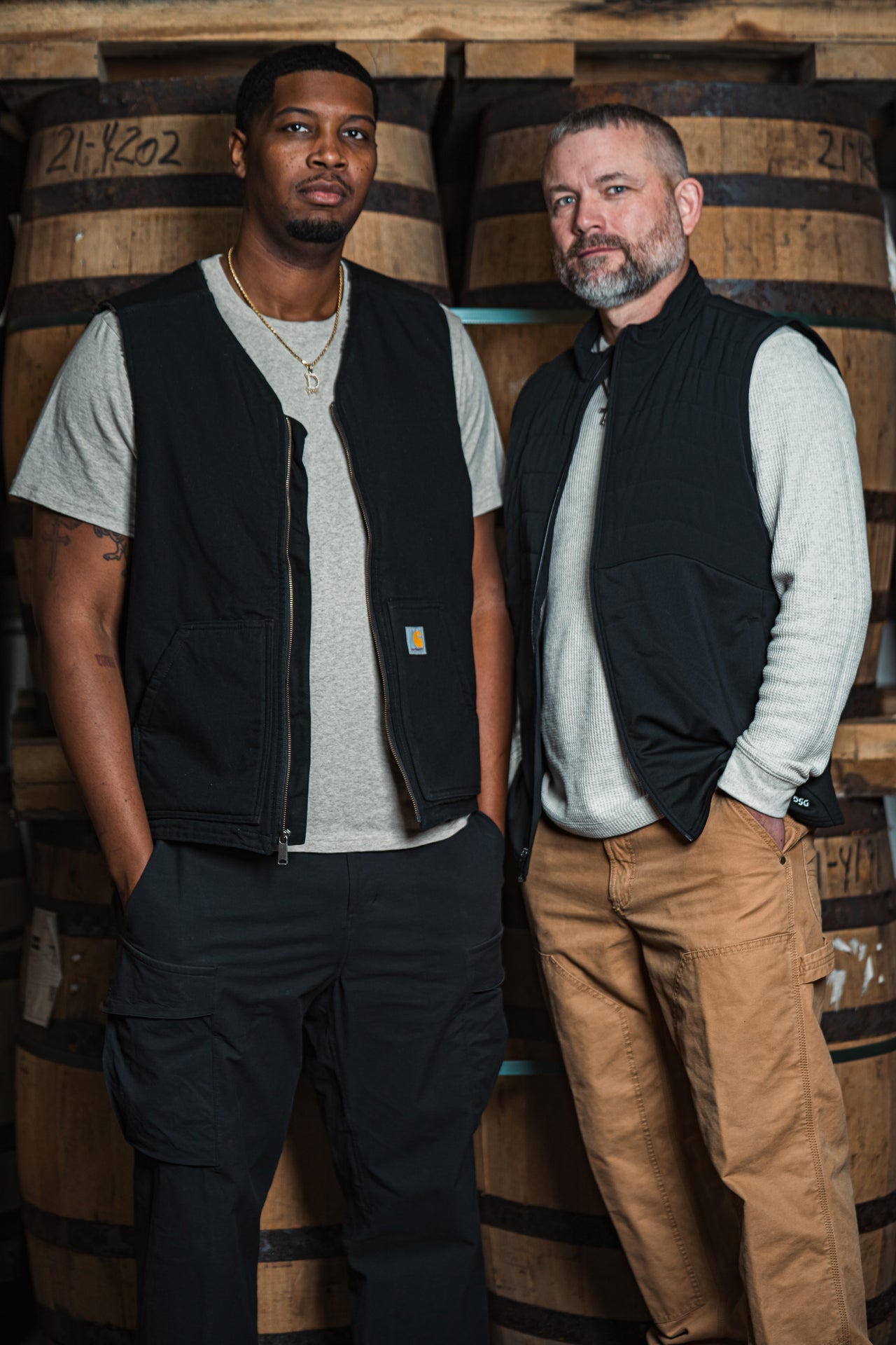 Da'Mon and Ricky Owners of River City Whiskey Posed in Front of Barrels