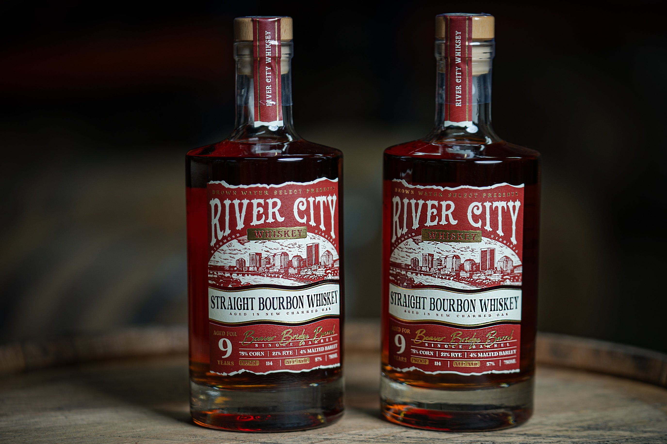 Two bottles of River City Whiskey On Top of a Barrel
