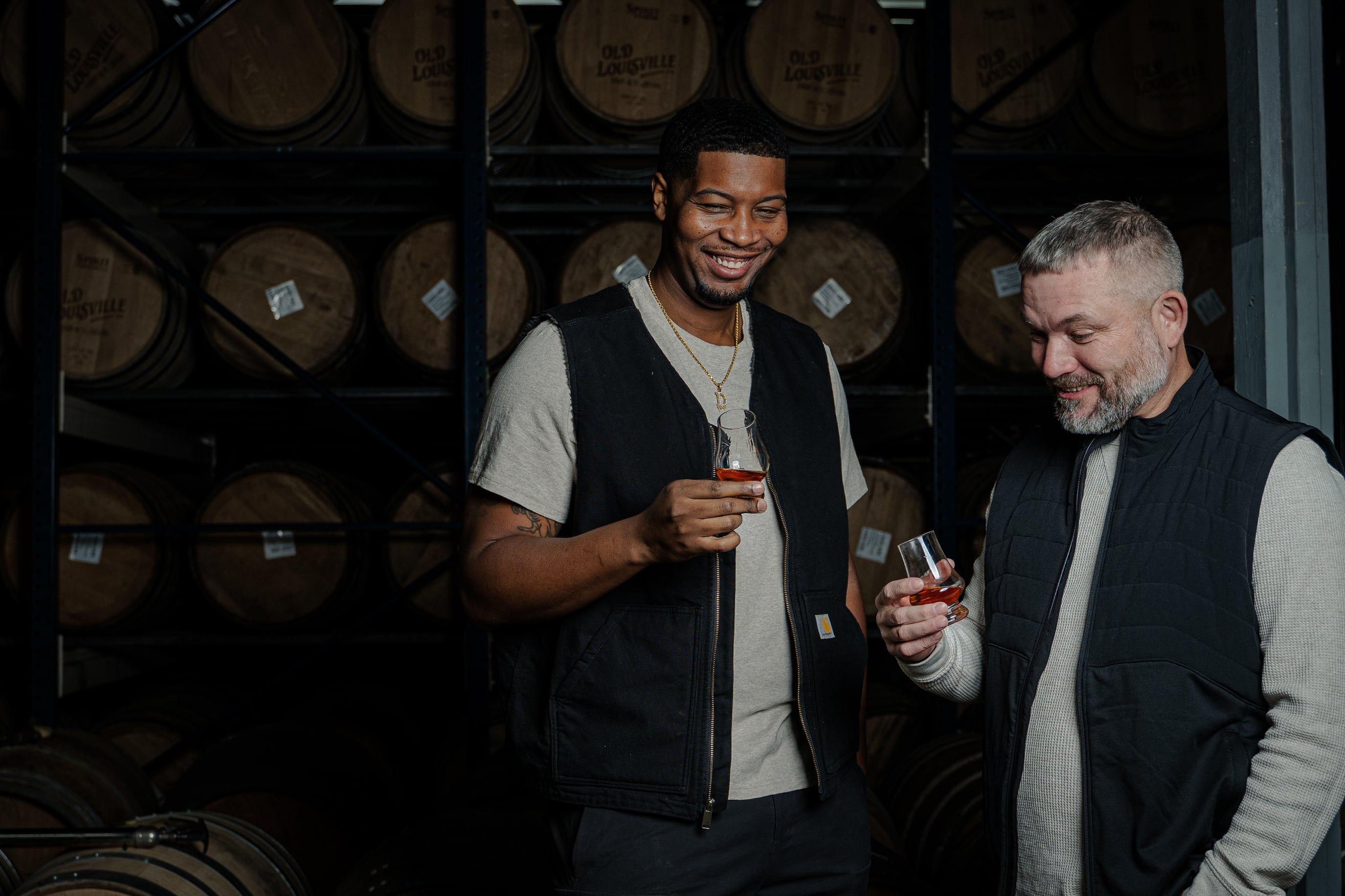 Da'Mon and Ricky looking impressed with bourbon flavors in the rickhouse holding glencairns of River City Whiskey