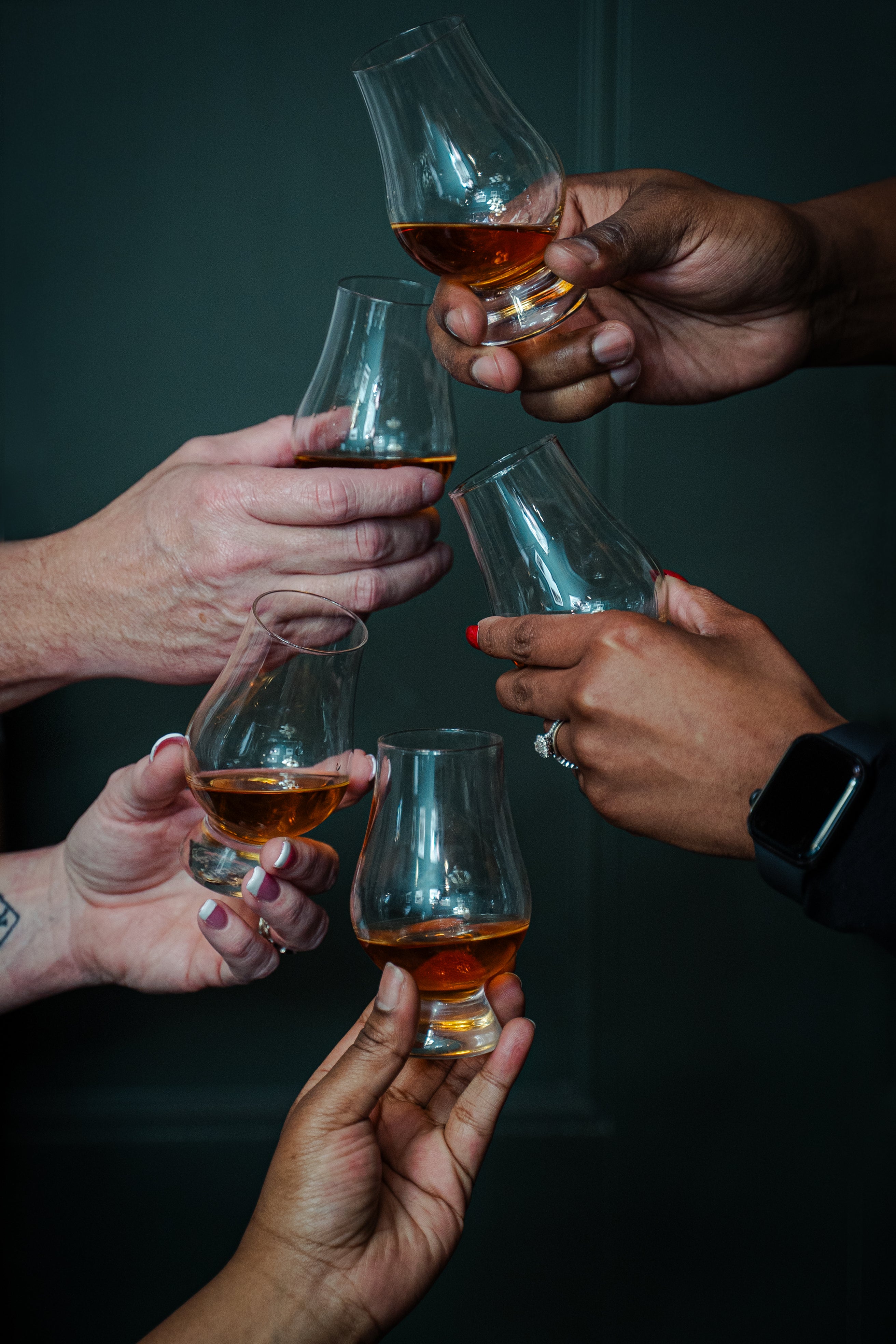 Friends cheersing glencairns full of River City Whiskey