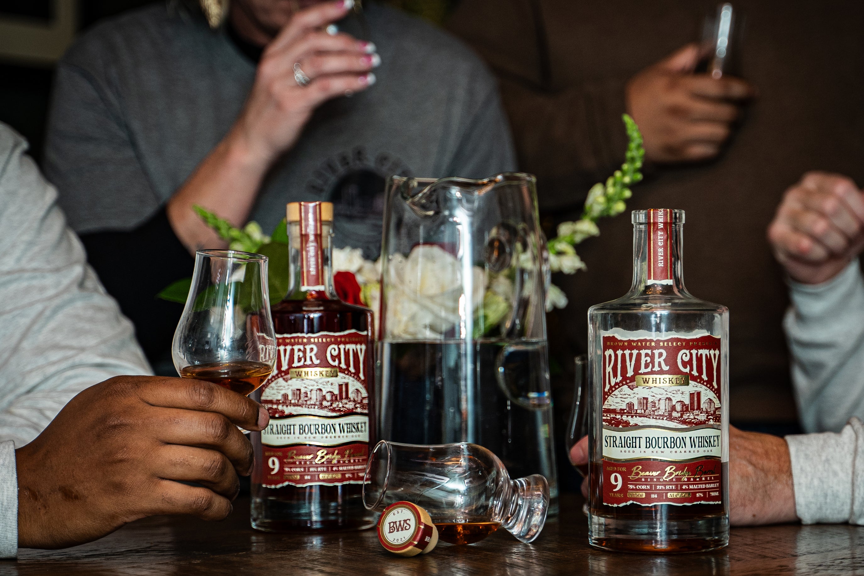 Friends enjoying conversations and pours of River City Whiskey